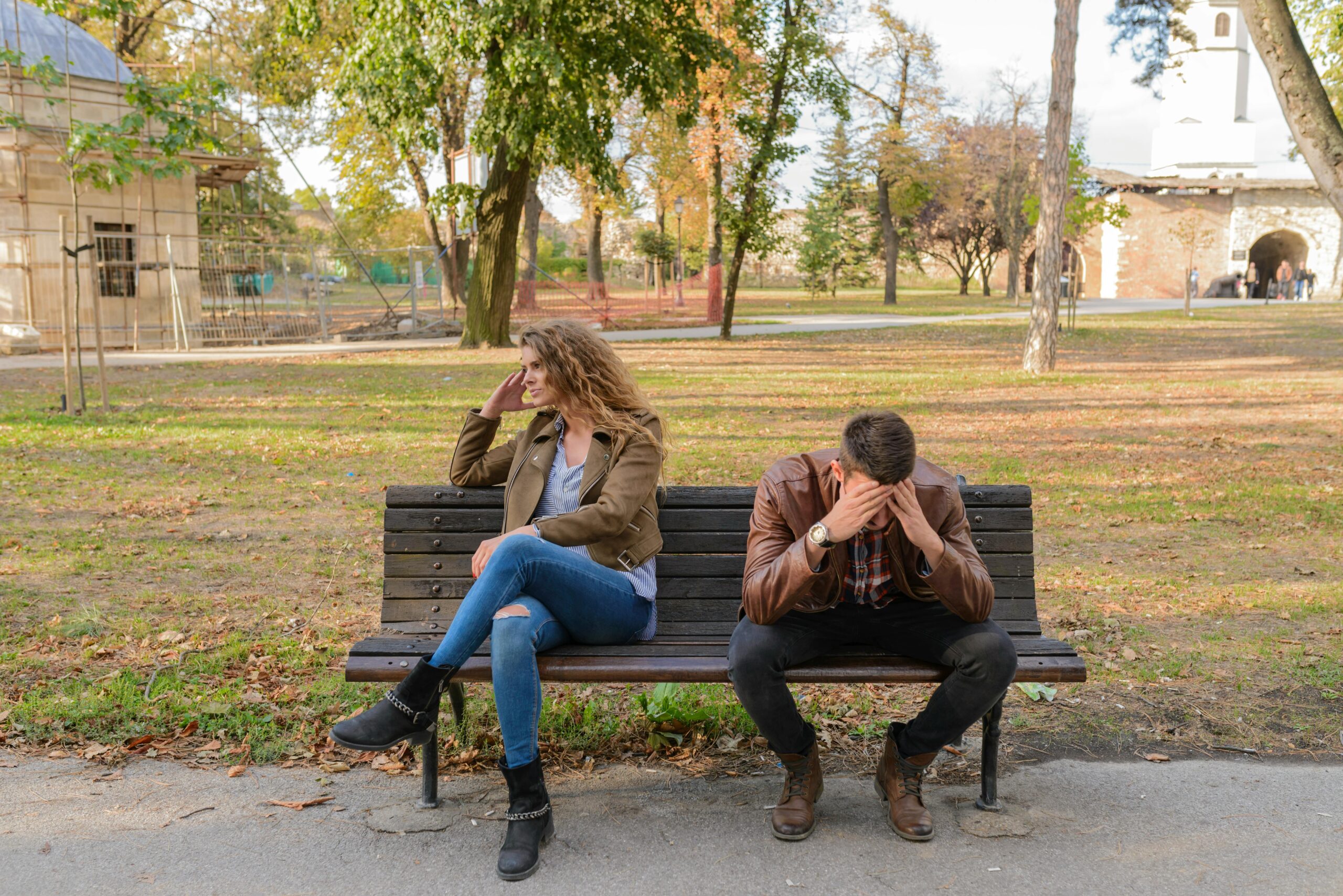 woman and man on a bench not talking