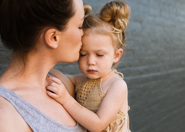 mother kissing child