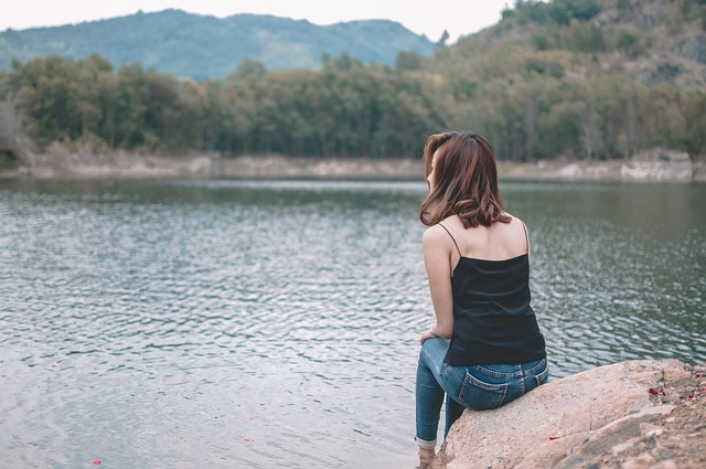 woman sitting by the lake