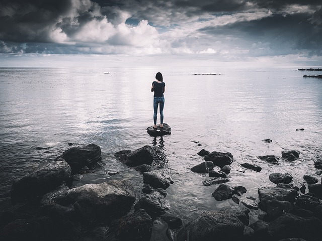 woman standing on rock in the water