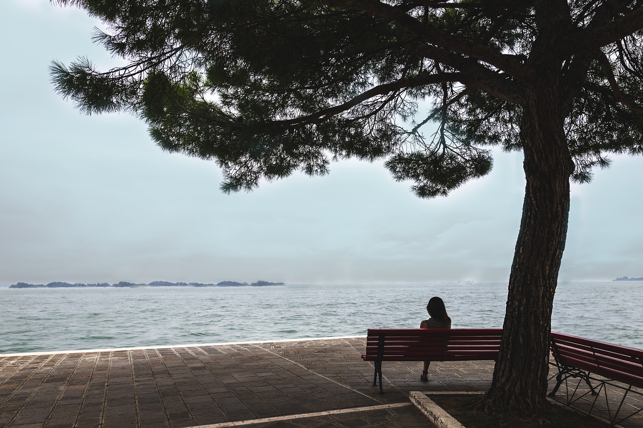 woman on bench by sea