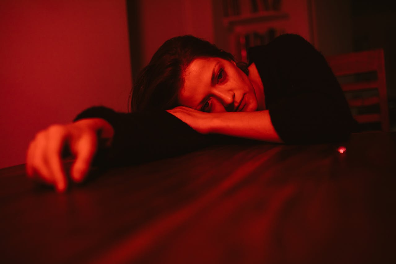 woman laying head on table